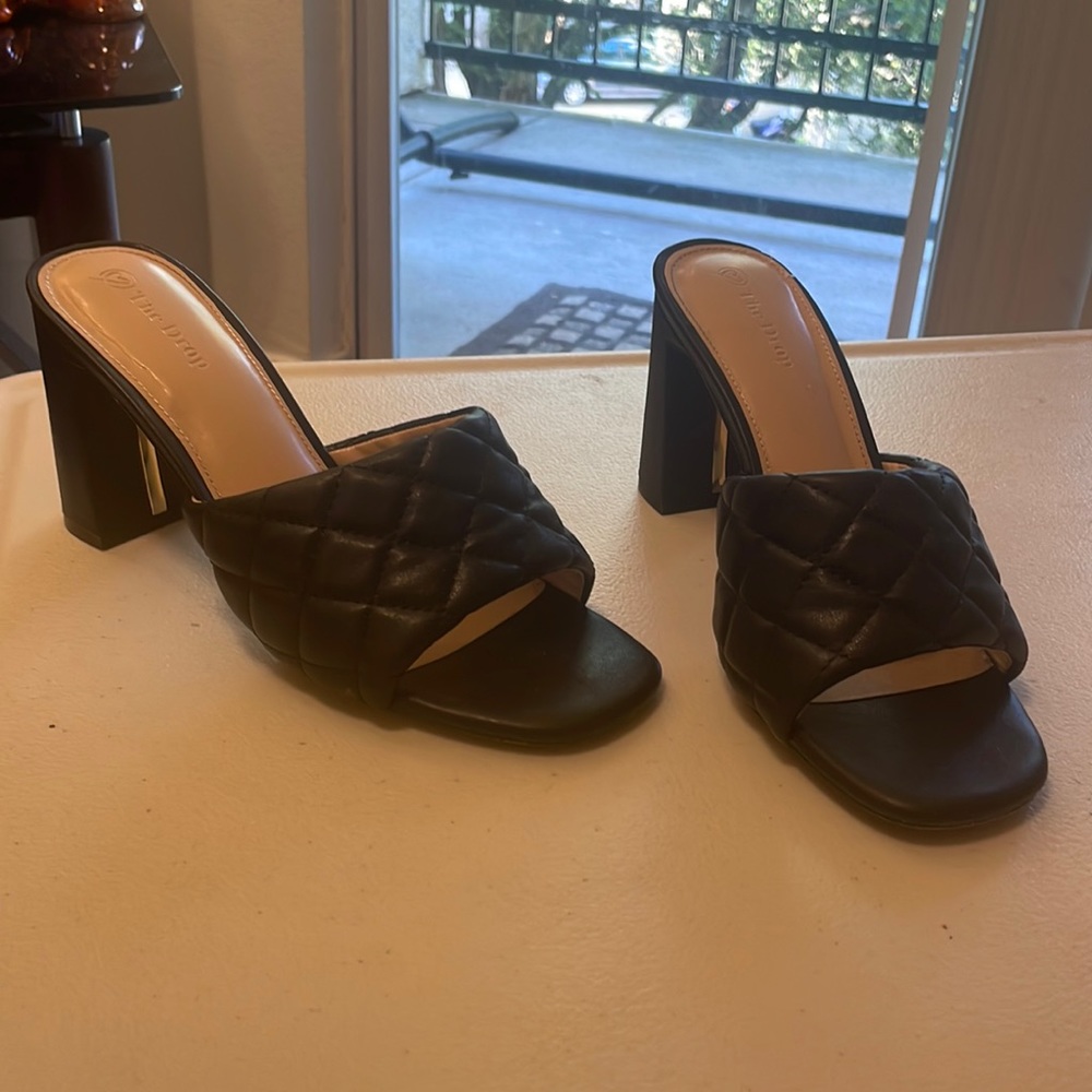 Black quilted open toe heels.